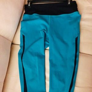 Lululemon turquoise crops with black detail.
